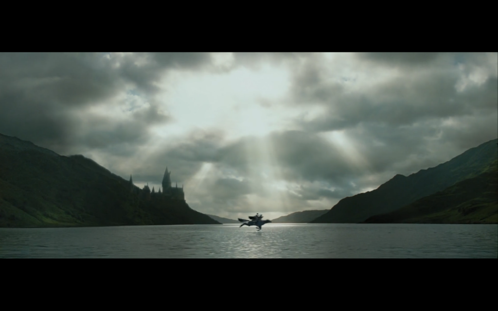 Harry and Buckbeak fly over the open landscape