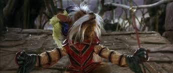 Sir Didymus, a movie character prevalent in this discussion, stood arms-open with his decorated jacket on show.